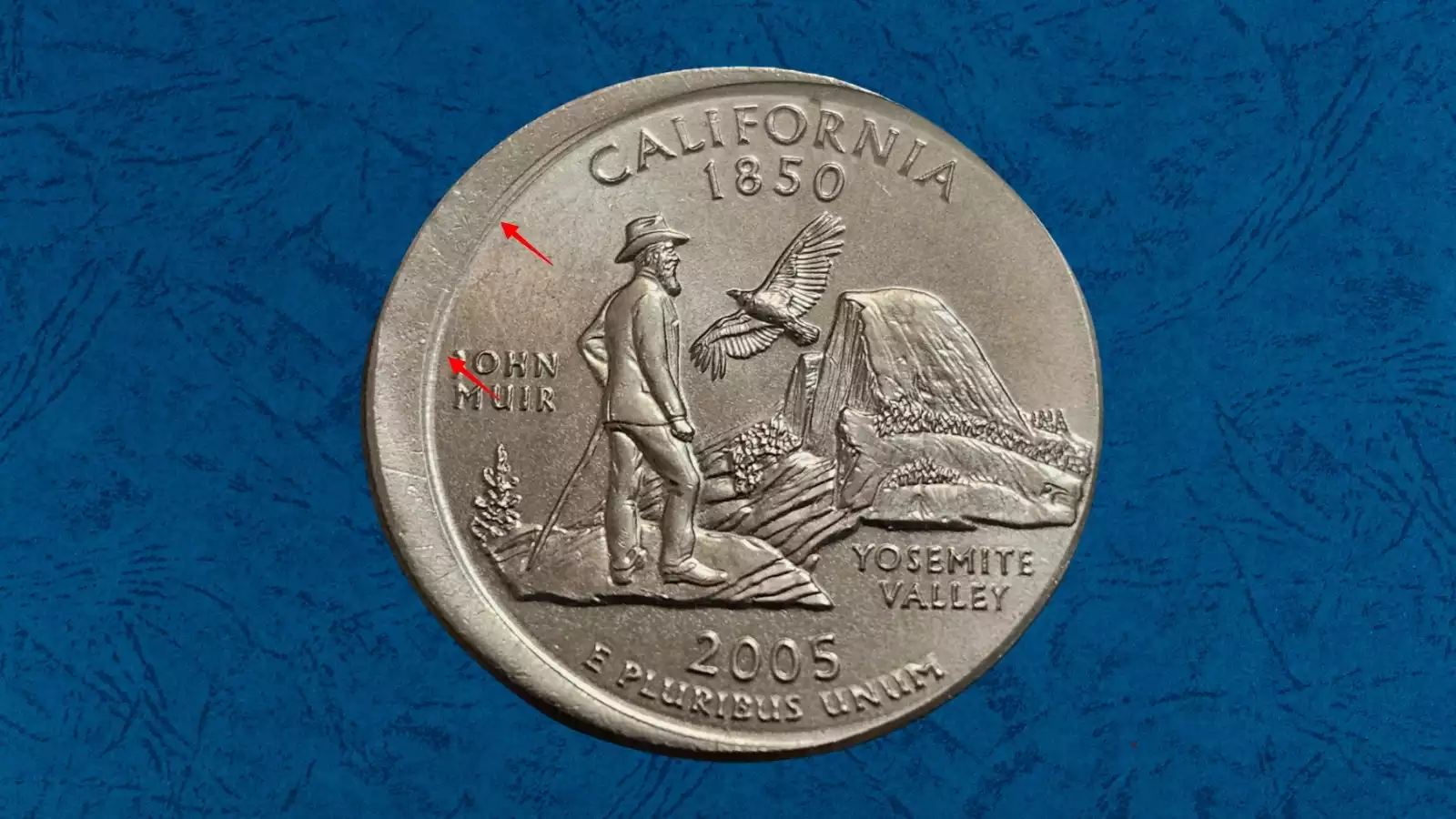 2005 state quarter off-center broad strike error showing design shifted off center with exposed blank rim area